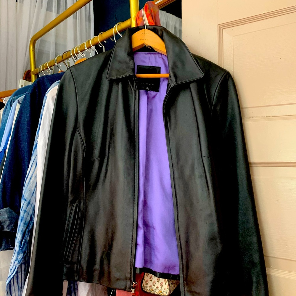 Genuine leather jacket, in black, size small, zipper closure.